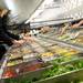 Shoppers reach in for items on a large salad bar at the Produce Station on Thursday afternoon. Melanie Maxwell | AnnArbor.com